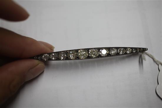 A Victorian gold, silver and graduated old mine cut diamond bar brooch, 85mm.